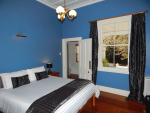 King-size bed in the bedroom of the Blue Room Suite